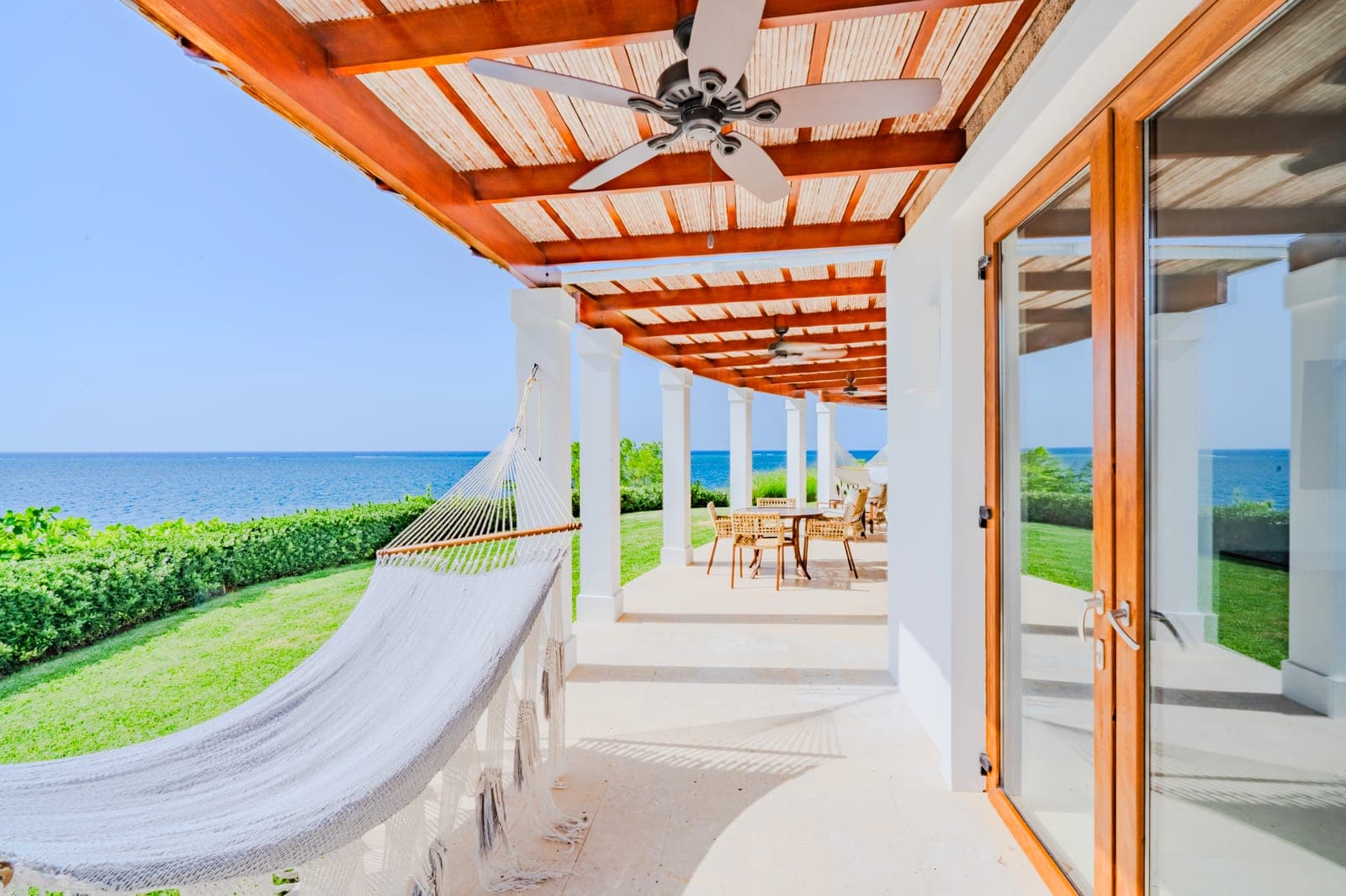 A shaded ocean-front veranda with a hammock, looking out over the Caribbean